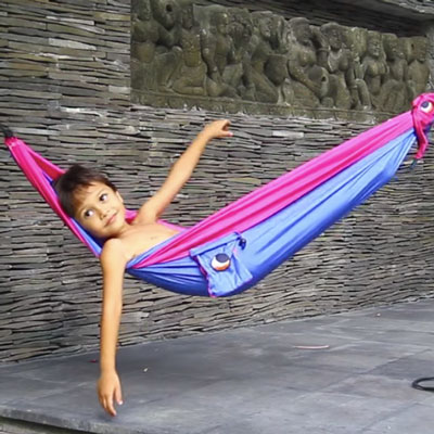 Young boy relaxing in the TTTMoon Child Hammock